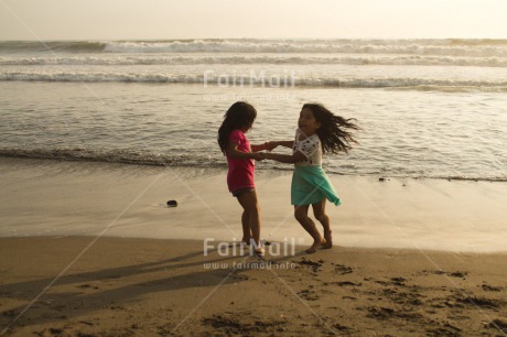 Fair Trade Photo 10-15 years, 5 -10 years, Activity, Beach, Children, Colour image, Dancing, Day, Emotions, Evening, Friendship, Happiness, Holding hands, Holiday, Horizontal, Ocean, People, Peru, Playing, Sand, Sea, Seasons, Sister, South America, Summer, Twins, Two, Water