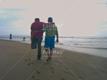 Fair Trade Photo Activity, Beach, Care, Colour image, Cooperation, Day, Friendship, Handicapped, Helping, Horizontal, Outdoor, People, Peru, Sea, Sickness, South America, Together, Two men, Walking
