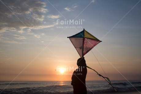 Fair Trade Photo Activity, Backlit, Beach, Colour image, Evening, Freedom, Kite, One boy, Outdoor, People, Peru, Playing, Sea, Silhouette, Sky, South America, Wind