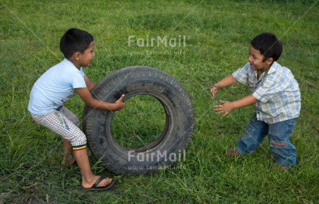 Fair Trade Photo Activity, Casual clothing, Clothing, Colour image, Cooperation, Day, Emotions, Friendship, Grass, Happiness, Horizontal, Outdoor, People, Peru, Playing, Rural, South America, Two boys