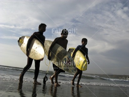 Fair Trade Photo Backlit, Beach, Colour image, Evening, Friendship, Group of boys, Horizontal, Outdoor, People, Peru, Sea, Silhouette, Sky, South America, Sport, Surf, Surfboard, Surfer, Together, Travel, Water