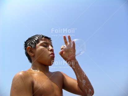 Fair Trade Photo Activity, Blowing, Blue, Brown, Colour image, Game, Growth, Horizontal, Looking away, One boy, Outdoor, People, Peru, Portrait halfbody, Soapbubble, South America, Streetlife, Transparent, Water