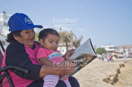 Fair Trade Photo Activity, Book, Care, Casual clothing, Clothing, Colour image, Day, Education, Family, Grandmother, Horizontal, Latin, One girl, One woman, Outdoor, People, Peru, Reading, South America, Teaching