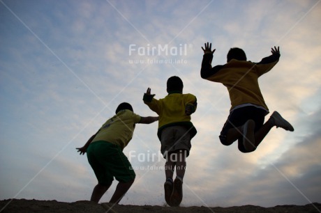 Fair Trade Photo Activity, Backlit, Casual clothing, Clothing, Colour image, Cooperation, Emotions, Evening, Friendship, Group of boys, Happiness, Jumping, Outdoor, People, Peru, Playing, Silhouette, South America, Sport, Together