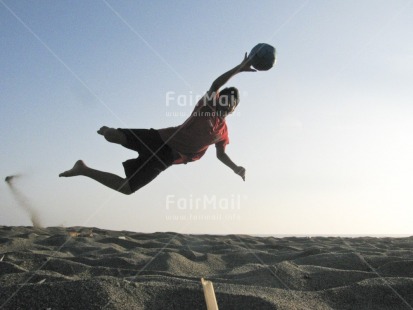 Fair Trade Photo 10-15 years, Activity, Ball, Beach, Colour image, Day, Horizontal, Jumping, Latin, Moving, One boy, Outdoor, People, Peru, Playing, Sand, Seasons, Sky, Soccer, South America, Sport, Summer