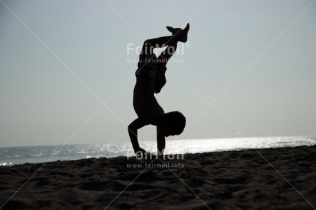 Fair Trade Photo Activity, Backlit, Beach, Colour image, Doing handstand, Evening, One boy, Outdoor, People, Peru, Sand, Silhouette, South America, Sport, Summer, Yoga