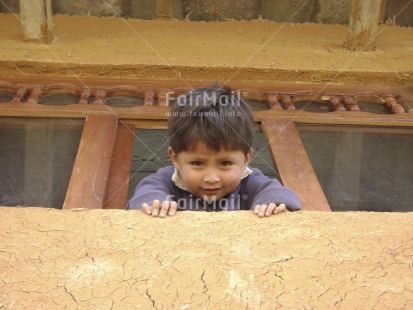 Fair Trade Photo Activity, Colour image, Cute, Horizontal, House, Latin, Looking at camera, Low angle view, One boy, People, Peru, Portrait headshot, Rural, South America, Thinking of you, Welcome home