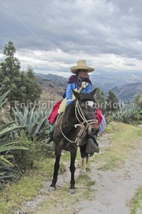 Fair Trade Photo Andes, Animals, Colour image, Condolence, Dailylife, Ethnic-folklore, Horse, Mountain, Multi-coloured, Nature, One woman, Outdoor, People, Peru, Portrait fullbody, Rural, Scenic, Sombrero, South America, Vertical