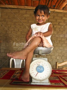 Fair Trade Photo Activity, Colour image, Cute, Day, Funny, Health, Indoor, One girl, People, Peru, Sitting, South America, Vertical, Weighing