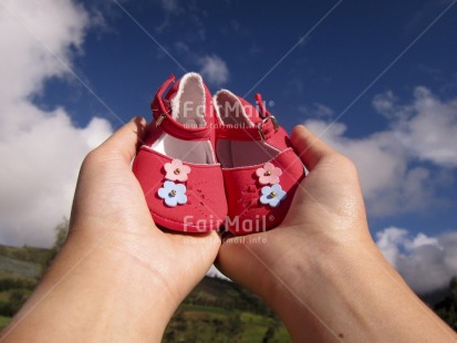 Fair Trade Photo Birth, Colour image, Focus on foreground, Hand, Horizontal, Multi-coloured, New baby, Outdoor, Peru, Pink, Shoe, South America, Tabletop