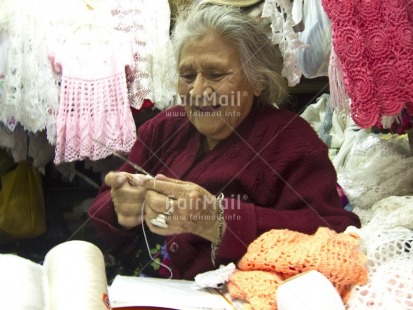 Fair Trade Photo 60-65 years, Activity, Colour image, Horizontal, Indoor, Knitting, Looking away, Market, One woman, People, Peru, Portrait halfbody, Sitting, Smiling, South America