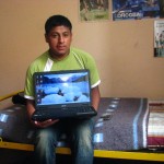 Juan Carlos with his new lap top in his bed room