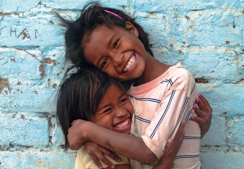 Fair Trade Photo Greeting Card 5-10_years, Activity, Colour image, Cute, Day, Emotions, Friendship, Fun, Girl, Happiness, Horizontal, Hug, Joy, Looking at camera, Love, Multi-coloured, Outdoor, People, Peru, Portrait halfbody, Smile, Smiling, South America, Street, Streetlife, Together, Two children, Two girls, Wall, Warmth, Youth