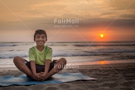 Fair Trade Photo Beach, Colour image, Horizontal, One boy, Peace, People, Sea, Smiling, Spirituality, Sunset, Wellness, Yoga