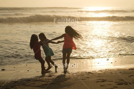 Fair Trade Photo 10-15 years, 5 -10 years, Activity, Beach, Children, Colour image, Dancing, Day, Emotions, Evening, Friendship, Happiness, Holding hands, Holiday, Horizontal, Ocean, People, Peru, Playing, Sand, Sea, Seasons, Sister, South America, Summer, Three, Twins, Water