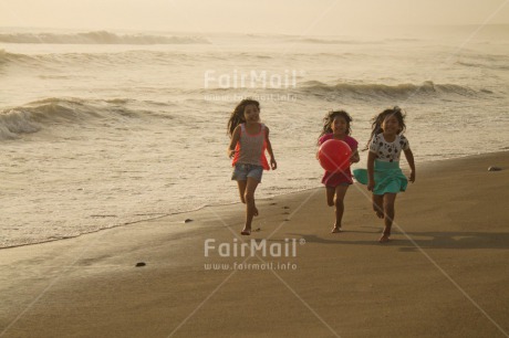 Fair Trade Photo 10-15 years, 5 -10 years, Activity, Ball, Beach, Children, Colour image, Day, Emotions, Evening, Friendship, Happiness, Holiday, Horizontal, Ocean, People, Peru, Playing, Running, Sand, Sea, Seasons, Sister, South America, Summer, Three, Twins, Water