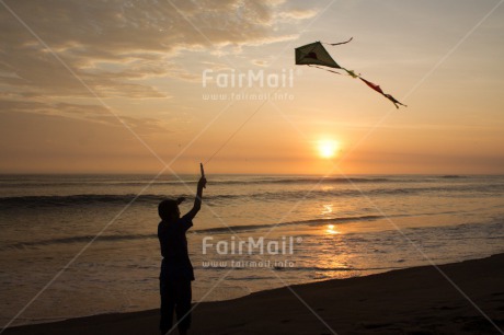 Fair Trade Photo Activity, Backlit, Beach, Clouds, Colour image, Evening, Freedom, Hope, Kite, One boy, Outdoor, People, Peru, Playing, Sea, Silhouette, Sky, South America, Summer, Sunset, Water