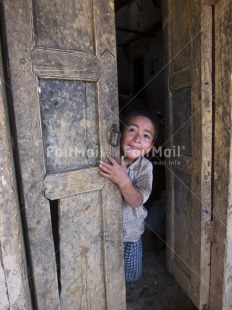 Fair Trade Photo 5 -10 years, Activity, Colour image, Day, Door, House, Latin, Looking at camera, One boy, One child, Outdoor, People, Peru, Portrait fullbody, Smiling, South America, Vertical
