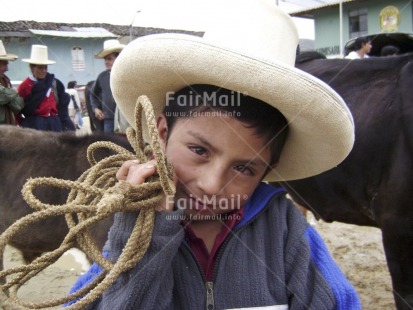 Fair Trade Photo Activity, Agriculture, Animals, Child labour, Clothing, Colour image, Cow, Hat, Horizontal, Looking at camera, Market, One boy, People, Peru, Portrait halfbody, Smiling, Social issues, South America