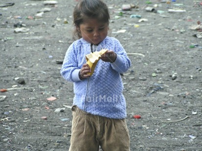 Fair Trade Photo Activity, Banana, Casual clothing, Child labour, Clothing, Colour image, Day, Eating, Food and alimentation, Fruits, Garbage, Garbage belt, Health, Horizontal, Hygiene, Looking away, One girl, Outdoor, People, Peru, Portrait fullbody, Recycle, Safety, Sanitation, South America