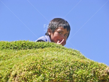 Fair Trade Photo 5 -10 years, Activity, Blue, Colour image, Cute, Day, Grass, Green, Horizontal, Latin, Looking at camera, One boy, One child, Outdoor, People, Peru, Portrait headshot, Reflection, Rural, Sky, South America