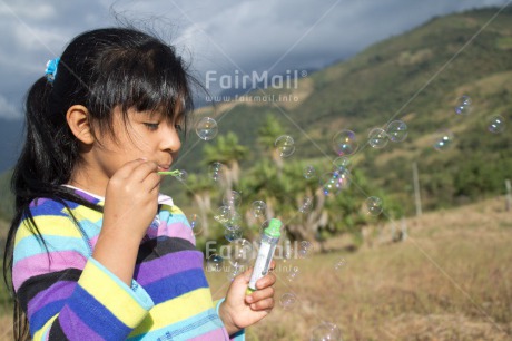 Fair Trade Photo 5 -10 years, Activity, Casual clothing, Clothing, Colour image, Latin, One girl, People, Peru, Playing, Rural, Soapbubble, South America