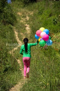 Fair Trade Photo Activity, Balloon, Birthday, Colour image, Day, Emotions, Green, Happiness, One girl, Outdoor, Party, People, Peru, Running, Rural, Smiling, South America, Vertical