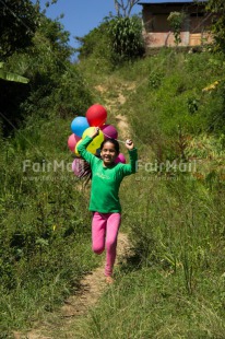 Fair Trade Photo Activity, Balloon, Birthday, Colour image, Day, Emotions, Green, Happiness, One girl, Outdoor, Party, People, Peru, Running, Rural, Smiling, South America, Vertical