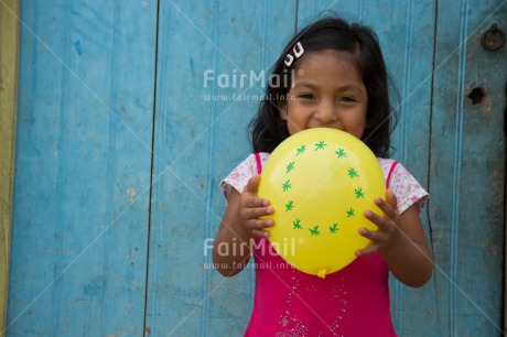 Fair Trade Photo 5 -10 years, Activity, Balloon, Birth, Birthday, Colour image, Horizontal, Latin, Looking at camera, New baby, One girl, People, Peru, Pink, Round, Smiling, South America, Yellow, Zero