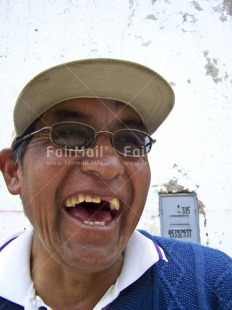 Fair Trade Photo Activity, Colour image, Emotions, Glasses, Happiness, Looking away, Multi-coloured, One man, Outdoor, People, Peru, Portrait headshot, Smile, Smiling, South America, Streetlife, Tooth, Vertical