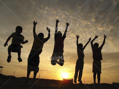 Fair Trade Photo Activity, Backlit, Beach, Colour image, Emotions, Friendship, Group of boys, Group of children, Happiness, Horizontal, Jumping, Outdoor, People, Peru, Playing, Sand, Silhouette, South America, Sun, Sunset, Together