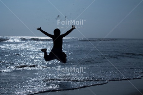 Fair Trade Photo Activity, Backlit, Beach, Colour image, Emotions, Evening, Freedom, Happiness, Jumping, One boy, Outdoor, People, Peru, Playing, Sea, Silhouette, Sky, South America, Sunset