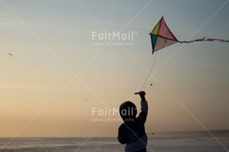 Fair Trade Photo Activity, Backlit, Beach, Colour image, Evening, Freedom, Kite, One boy, Outdoor, People, Peru, Playing, Sea, Silhouette, Sky, South America, Wind
