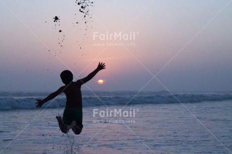 Fair Trade Photo Activity, Backlit, Beach, Colour image, Evening, Freedom, Jumping, One boy, Outdoor, People, Peru, Playing, Sea, Silhouette, Sky, South America, Sunset