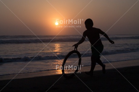 Fair Trade Photo Activity, Backlit, Beach, Colour image, Emotions, Evening, Happiness, One boy, Outdoor, People, Peru, Playing, Running, Sand, Sea, Silhouette, South America, Summer, Sunset