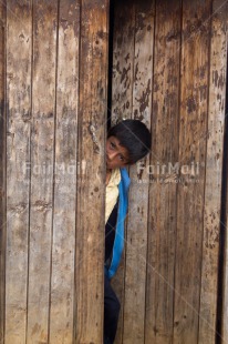 Fair Trade Photo 5 -10 years, Activity, Colour image, Door, House, Latin, Looking at camera, One boy, People, Peru, South America, Vertical, Wood