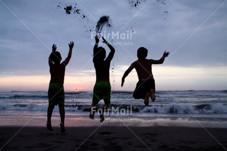 Fair Trade Photo Activity, Beach, Colour image, Emotions, Evening, Friendship, Group of boys, Happiness, Horizontal, Jumping, Outdoor, People, Peru, Playing, Shooting style, Silhouette, South America, Summer, Sunset, Together