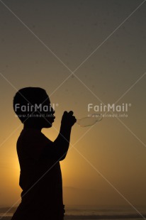 Fair Trade Photo Activity, Colour image, Dreaming, Evening, One boy, Outdoor, People, Peru, Playing, Soapbubble, South America, Spirituality, Sunset, Vertical