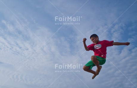 Fair Trade Photo 10-15 years, Activity, Blue, Casual clothing, Clothing, Clouds, Colour image, Emotions, Freedom, Happiness, Health, Horizontal, Jumping, Latin, One boy, People, Peru, Sky, Smiling, South America, Sport, Summer
