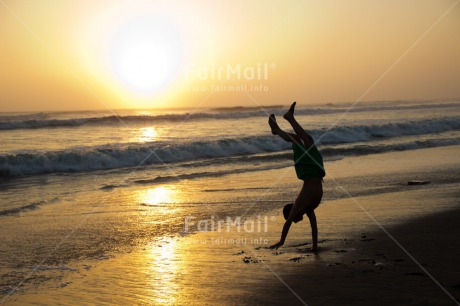 Fair Trade Photo 5 -10 years, Activity, Backlit, Beach, Colour image, Doing handstand, Evening, Freedom, One boy, Outdoor, People, Peru, Playing, Sea, Silhouette, Sky, South America, Sport, Yoga