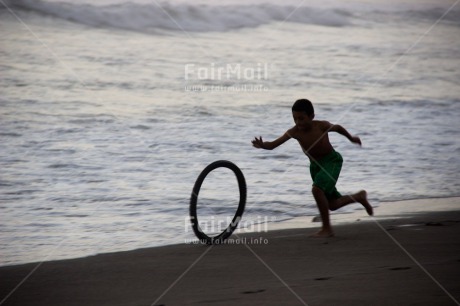 Fair Trade Photo 5 -10 years, Activity, Backlit, Beach, Colour image, Evening, Freedom, One boy, Outdoor, People, Peru, Playing, Running, Sea, Silhouette, South America, Sport