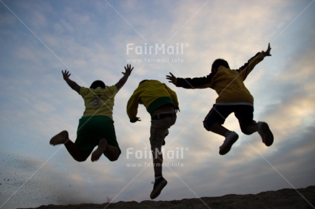 Fair Trade Photo Activity, Backlit, Casual clothing, Clothing, Colour image, Cooperation, Emotions, Evening, Friendship, Group of boys, Happiness, Jumping, Outdoor, People, Peru, Playing, Silhouette, South America, Sport, Together