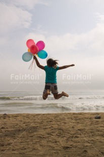 Fair Trade Photo Activity, Balloon, Beach, Birthday, Celebrating, Child, Colour image, Day, Emotions, Friendship, Girl, Happiness, Holding, Holiday, Jumping, Multi-coloured, Ocean, Outdoor, People, Peru, Sand, Sea, Seasons, Sister, South America, Summer, Vertical, Water