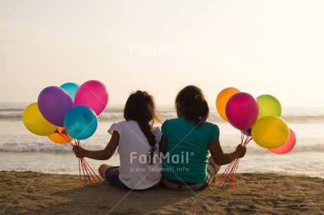 Fair Trade Photo Activity, Balloon, Beach, Birthday, Celebrating, Child, Colour image, Day, Emotions, Friendship, Girl, Happiness, Holding, Holiday, Horizontal, Multi-coloured, Ocean, Outdoor, People, Peru, Sand, Sea, Seasons, Sister, Sitting, South America, Summer, Water
