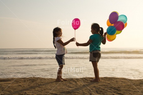 Fair Trade Photo Activity, Balloon, Beach, Birthday, Celebrating, Child, Colour image, Day, Emotions, Friendship, Gift, Girl, Happiness, Holding, Holiday, Horizontal, Multi-coloured, Ocean, Outdoor, People, Peru, Sand, Sea, Seasons, Sister, South America, Standing, Summer, Water