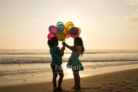 Fair Trade Photo Activity, Balloon, Beach, Birthday, Celebrating, Child, Colour image, Day, Emotions, Evening, Friendship, Gift, Girl, Happiness, Holding, Holiday, Horizontal, Multi-coloured, Ocean, Outdoor, People, Peru, Sand, Sea, Seasons, Sister, South America, Standing, Summer, Sunset, Water