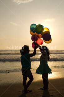 Fair Trade Photo Activity, Balloon, Beach, Birthday, Celebrating, Child, Colour image, Day, Emotions, Evening, Friendship, Gift, Girl, Happiness, Holding, Holiday, Multi-coloured, Ocean, Outdoor, People, Peru, Sand, Sea, Seasons, Sister, South America, Standing, Summer, Sunset, Vertical, Water