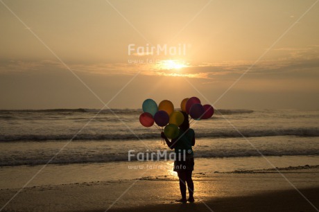 Fair Trade Photo Activity, Balloon, Beach, Birthday, Celebrating, Child, Colour image, Day, Emotions, Evening, Friendship, Girl, Happiness, Holding, Holiday, Horizontal, Multi-coloured, Ocean, Outdoor, People, Peru, Sand, Sea, Seasons, Sister, South America, Standing, Summer, Sunset, Water