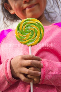Fair Trade Photo Birthday, Colour image, Day, Emotions, Girl, Hands, Happiness, Latin, Lollipop, Outdoor, People, Peru, Pink, Smile, Smiling, South America, Sweets, Vertical
