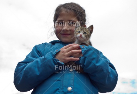Fair Trade Photo 5 -10 years, Activity, Animals, Care, Casual clothing, Cat, Clothing, Cute, Day, Horizontal, Latin, Looking at camera, Love, One girl, Outdoor, People, Portrait halfbody